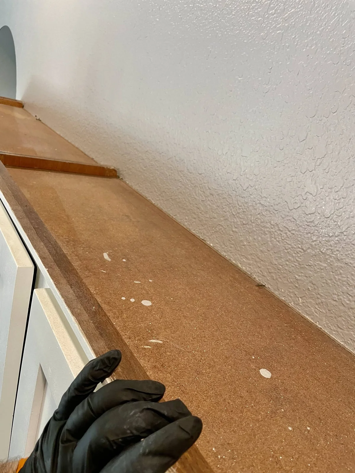 Dusty top of tall cabinetry before detailed cleaning