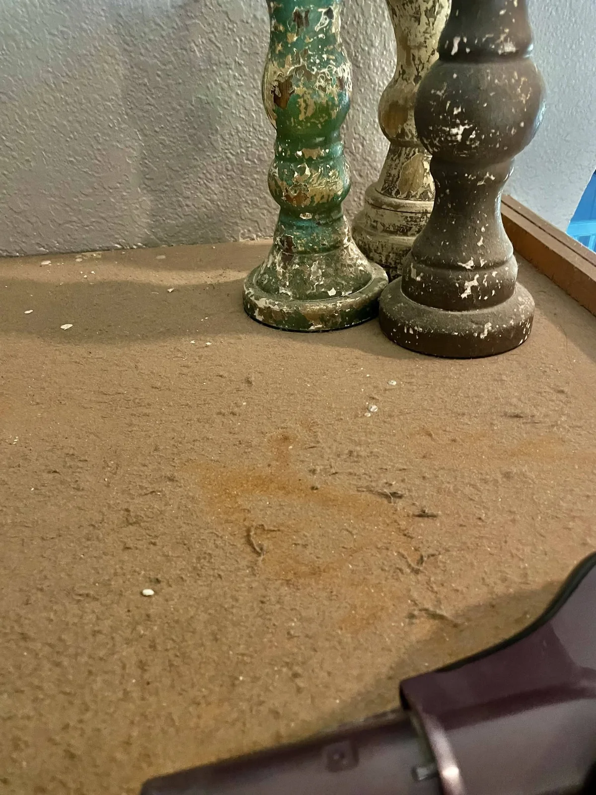 Close view of dust on a cabinet top before detailed cleaning