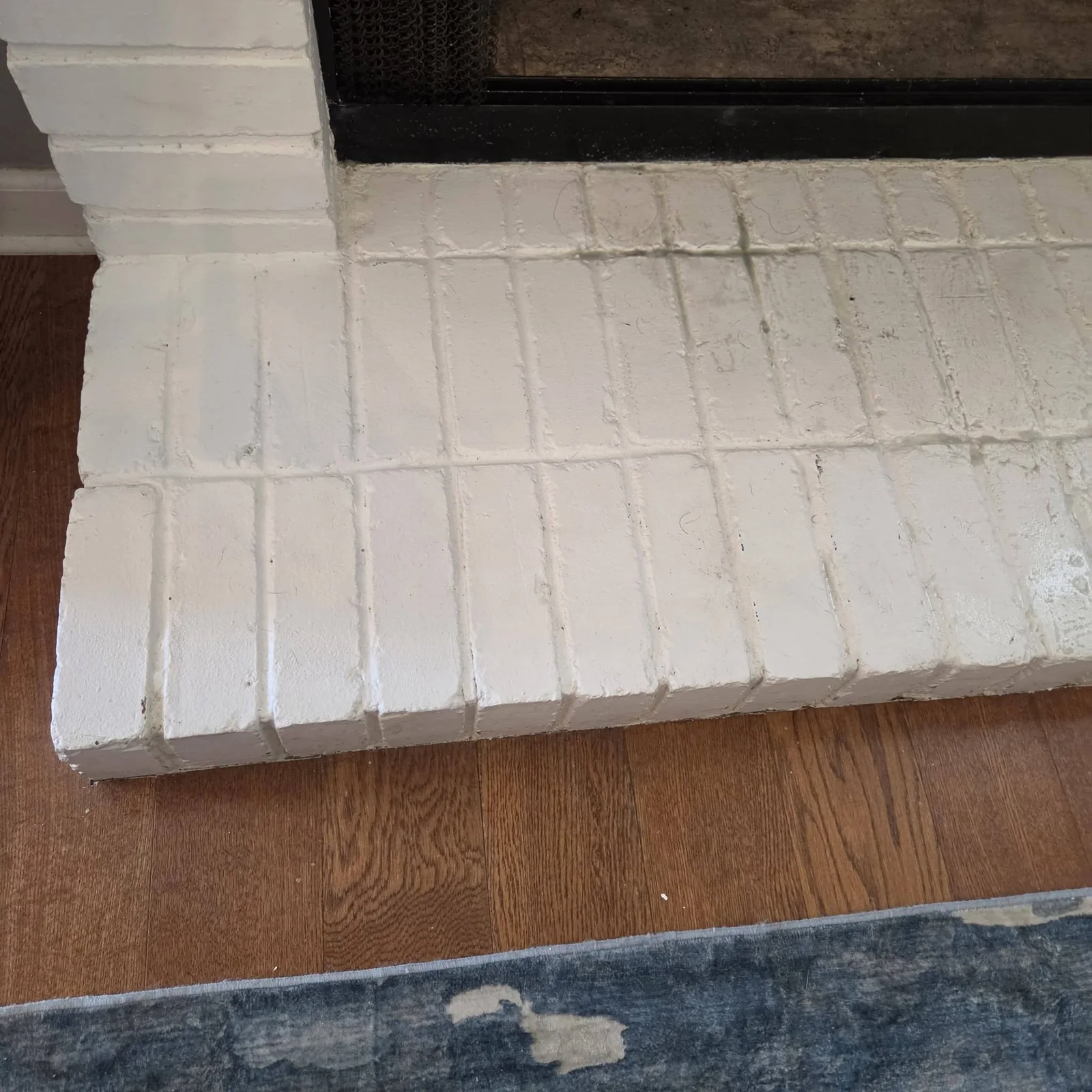 Painted fireplace hearth detail before cleaning