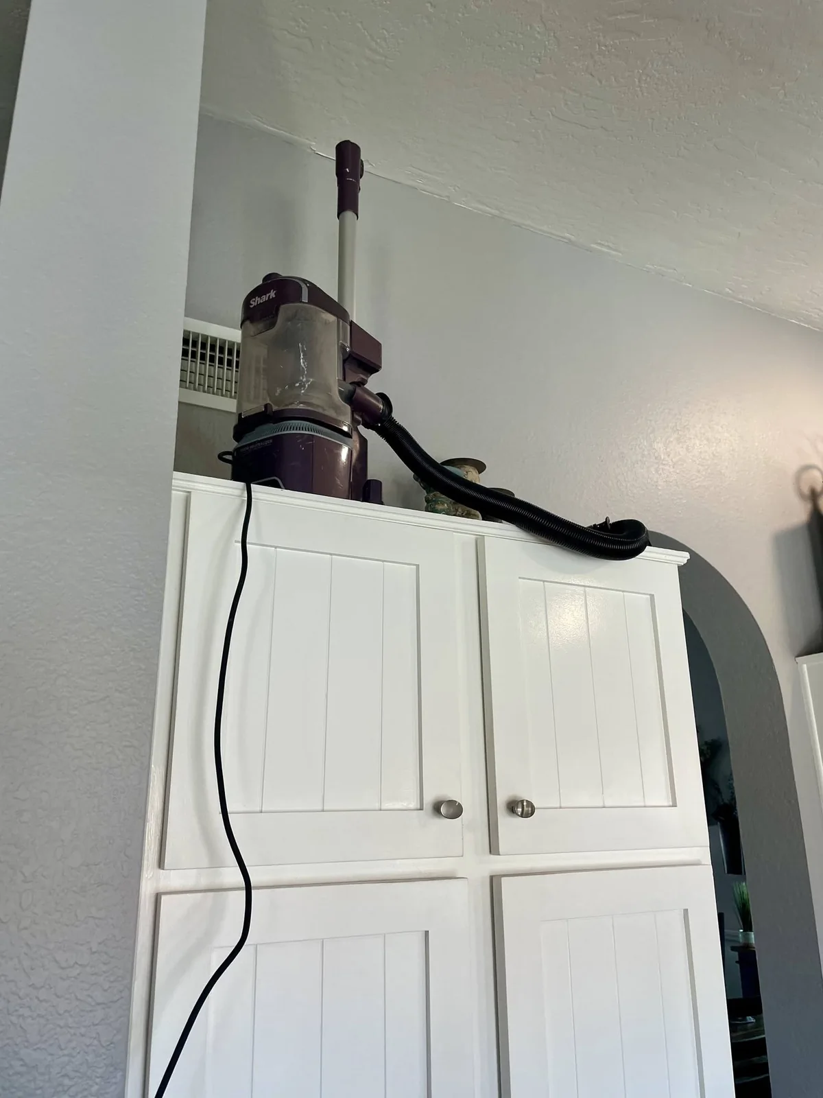 Detail cleaning above kitchen cabinetry